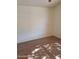 Vacant bedroom showcasing wood-look tile flooring and neutral wall color at 2434 S Colleen --, Mesa, AZ 85210