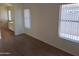 Bright bedroom featuring wood-look floors and two windows with horizontal blinds at 2434 S Colleen --, Mesa, AZ 85210