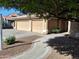 Landscaped front yard with walkway leading to the home's entrance and a three-car garage at 2434 S Colleen --, Mesa, AZ 85210