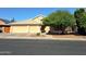 Inviting home showcasing desert landscaping, a mature shade tree, and a three-car garage at 2434 S Colleen --, Mesa, AZ 85210