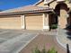 Attractive home with desert landscaping, a three-car garage, and a tile roof at 2434 S Colleen --, Mesa, AZ 85210
