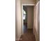 Hallway features wood-look tile flooring and leads to a bedroom with an arched window at 2434 S Colleen --, Mesa, AZ 85210