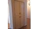 Hallway with a storage cabinet featuring four doors and dark hardware for interior decor and home organization at 2434 S Colleen --, Mesa, AZ 85210