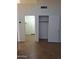 Neutral hallway with tile flooring, open doors, and a closet at 2434 S Colleen --, Mesa, AZ 85210