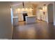 The kitchen features white cabinets, an island, and modern appliances, flowing into the open-concept living space at 2434 S Colleen --, Mesa, AZ 85210