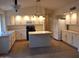 Bright kitchen features an island, white cabinetry, and modern appliances for a stylish and functional space at 2434 S Colleen --, Mesa, AZ 85210