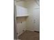 Functional laundry room with upper cabinets, shelving, and a utility sink hookup at 2434 S Colleen --, Mesa, AZ 85210