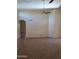 A large living area has tile floors and an arched doorway, showcasing the home's open layout at 2434 S Colleen --, Mesa, AZ 85210