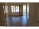 Inviting living room with wood-look floors and natural light, leading to a patio entrance at 2434 S Colleen --, Mesa, AZ 85210