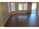 Spacious living room with wood-look floors and plenty of natural light from the windows at 2434 S Colleen --, Mesa, AZ 85210