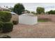 Backyard shed with pebble ground cover, enclosed by a brick wall creating a private outdoor area at 2585 E Carob Dr, Gilbert, AZ 85298