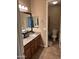 Bathroom with granite countertop, mirror, vanity, and toilet at 2585 E Carob Dr, Gilbert, AZ 85298