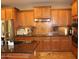 Gourmet kitchen featuring granite countertops, stainless steel appliances, and ample cabinet space at 2585 E Carob Dr, Gilbert, AZ 85298