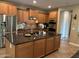 Kitchen with dark countertops, stainless steel appliances, and ample cabinet space at 2585 E Carob Dr, Gilbert, AZ 85298