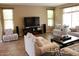 Bright and airy living room with large windows, tile flooring, and comfortable seating at 2585 E Carob Dr, Gilbert, AZ 85298