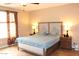 Comfortable main bedroom features a ceiling fan, natural light, and carpet flooring at 2585 E Carob Dr, Gilbert, AZ 85298