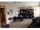 Inviting home office featuring built in bookshelves, a desk and neutral walls at 2585 E Carob Dr, Gilbert, AZ 85298