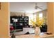 Bright office space with a black desk, bookshelves, and neutral walls at 2585 E Carob Dr, Gilbert, AZ 85298