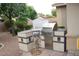 Outdoor kitchen and grill in the backyard at 2585 E Carob Dr, Gilbert, AZ 85298
