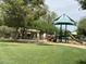 Community playground features a park shelter, slides, and green space for recreational activities at 2585 E Carob Dr, Gilbert, AZ 85298