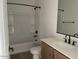 Full bathroom with tub/shower combo and modern vanity with black fixtures at 26119 N 23Rd Ave, Phoenix, AZ 85085