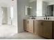 Bathroom featuring a double vanity and large mirror at 26119 N 23Rd Ave, Phoenix, AZ 85085