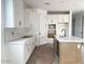 Modern kitchen with white cabinets, subway tile backsplash, and a center island with a sink at 26119 N 23Rd Ave, Phoenix, AZ 85085