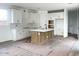Stylish kitchen with white cabinets, subway tile backsplash, and a central island with seating at 26119 N 23Rd Ave, Phoenix, AZ 85085