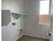 Bright laundry room with shelf, window, and connections for appliances at 26119 N 23Rd Ave, Phoenix, AZ 85085