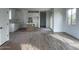 Open living space flowing into a modern kitchen, featuring wood-look tile flooring and ample light at 26119 N 23Rd Ave, Phoenix, AZ 85085