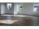 Bright living room featuring wood-look tile flooring and large windows for ample natural light at 26119 N 23Rd Ave, Phoenix, AZ 85085