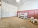 Charming Bedroom with pink accent wall and white crib at 2821 S Skyline Dr # 156, Mesa, AZ 85212