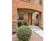 Charming front porch area with black chairs, stone accents, and desert landscaping at 2821 S Skyline Dr # 156, Mesa, AZ 85212
