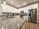 A chef's kitchen featuring stainless steel appliances, granite countertops, and ample cabinet space at 2821 S Skyline Dr # 156, Mesa, AZ 85212