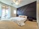 Modern main bedroom with accent wall, carpet, and a sliding glass door at 2821 S Skyline Dr # 156, Mesa, AZ 85212