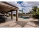 Backyard oasis showcases a stunning pool, mature trees, and relaxing lounge areas at 3053 S Canfield --, Mesa, AZ 85212