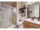 Bathroom with glass-enclosed shower, framed mirror, stylish vanity, and decorative shelving at 3053 S Canfield --, Mesa, AZ 85212