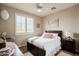 Bedroom featuring a large bed, shuttered windows, ceiling fan, and neutral carpet at 3053 S Canfield --, Mesa, AZ 85212