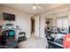 Bright bedroom featuring a treadmill, TV, ceiling fan, mirrored closet doors, and neutral carpet at 3053 S Canfield --, Mesa, AZ 85212