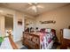 Bedroom featuring a large bed, shuttered windows, ceiling fan, and neutral carpet at 3053 S Canfield --, Mesa, AZ 85212