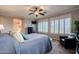 Bedroom featuring a sitting area, ceiling fan, shutters, and archway leading to ensuite bathroom at 3053 S Canfield --, Mesa, AZ 85212
