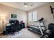 Bedroom/exercise area with shutters, weights, desk with gaming setup and treadmill at 3053 S Canfield --, Mesa, AZ 85212