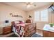 Bedroom with wood furniture, shuttered windows, ceiling fan, and neutral carpet at 3053 S Canfield --, Mesa, AZ 85212