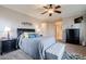 Bedroom featuring a ceiling fan, nightstands, and a cushioned bench at the foot of the bed at 3053 S Canfield --, Mesa, AZ 85212