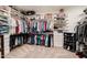 Spacious walk-in closet with custom shelving, ample hanging space, and carpeted flooring at 3053 S Canfield --, Mesa, AZ 85212
