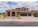 A charming two-story home featuring a three-car garage, a well-manicured front yard, and an inviting entrance at 3053 S Canfield --, Mesa, AZ 85212