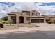 A charming two-story home featuring a three-car garage, a well-manicured front yard, and an inviting entrance at 3053 S Canfield --, Mesa, AZ 85212