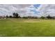 Open green field with mature trees is perfect for outdoor activities at 3053 S Canfield --, Mesa, AZ 85212