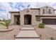 Inviting entrance featuring a walkway with landscape lighting, desert landscaping, and covered porch at 3053 S Canfield --, Mesa, AZ 85212