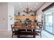 Open-concept living with large wood table, kitchen with island, and access to the patio at 3053 S Canfield --, Mesa, AZ 85212